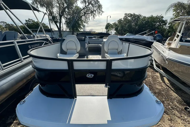 Slide: The Image of 2026 Hurricane FunDeck 1960 REF OB boat, sleek design, docked outdoors. - 4