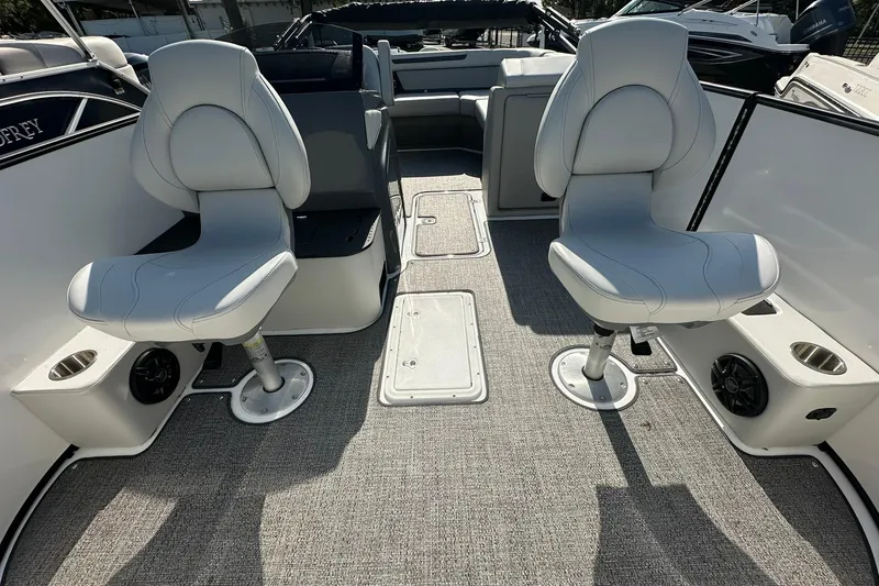 Slide: The Image of 2026 Hurricane FunDeck 1960 REF OB boat interior with two swivel seats and carpeted flooring. - 6