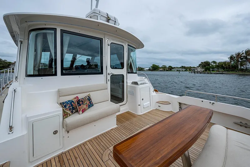 Slide: The Image of Luxurious 2014 Grand Banks 46 Eastbay SX yacht with elegant deck seating and scenic water view. - 12