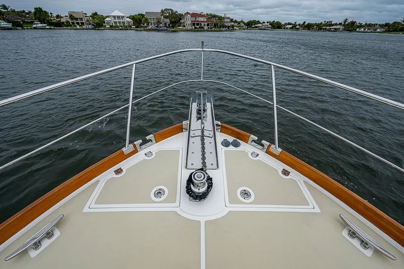 Slide: The Image of Bow view of 2014 Grand Banks 46 Eastbay SX yacht on calm waters. - 16
