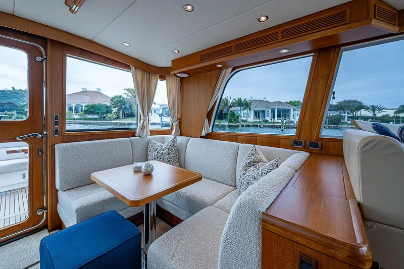 Slide: The Image of Luxurious interior of 2014 Grand Banks 46 Eastbay SX yacht with elegant seating and scenic views. - 18
