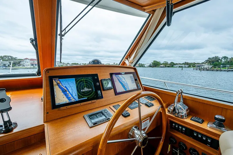 Slide: The Image of Helm of 2014 Grand Banks 46 Eastbay SX yacht with navigation screens and steering wheel. - 25