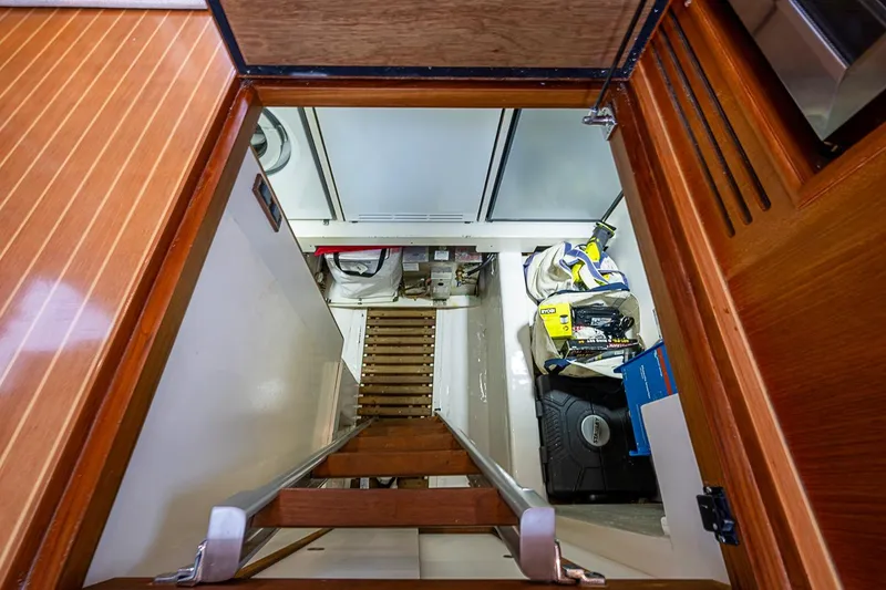 Slide: The Image of Engine room access on 2014 Grand Banks 46 Eastbay SX yacht with wooden ladder and storage. - 31