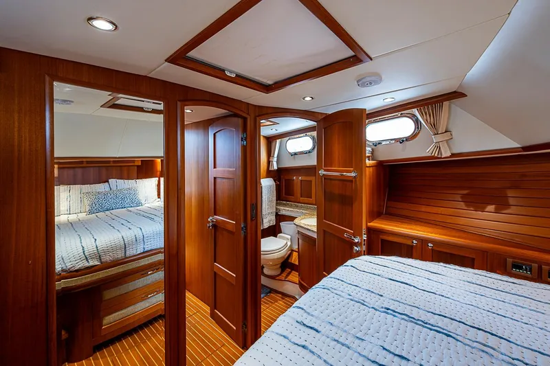 Slide: The Image of Luxurious 2014 Grand Banks 46 Eastbay SX yacht cabin with wood interior and cozy bedding. - 36