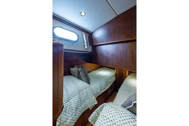 Slide: The Image of Cabin interior of 2014 Grand Banks 46 Eastbay SX with twin beds and wooden paneling. - 41