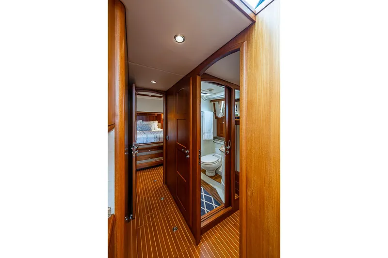 Slide: The Image of Luxurious interior of 2014 Grand Banks 46 Eastbay SX yacht, featuring wood finishes and cozy cabin. - 48