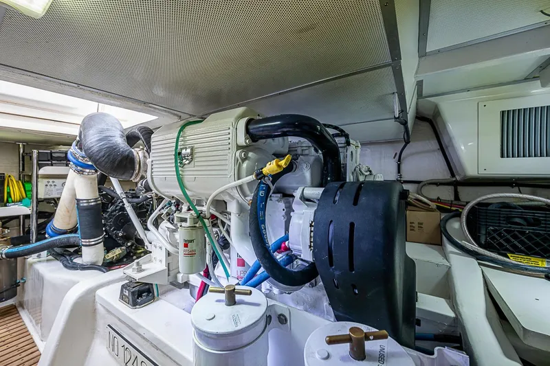 Slide: The Image of Engine room of 2014 Grand Banks 46 Eastbay SX yacht, showcasing mechanical components. - 54