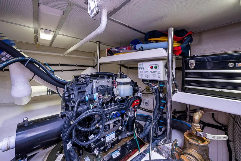 Slide: The Image of Engine room of 2014 Grand Banks 46 Eastbay SX with mechanical components and storage. - 55