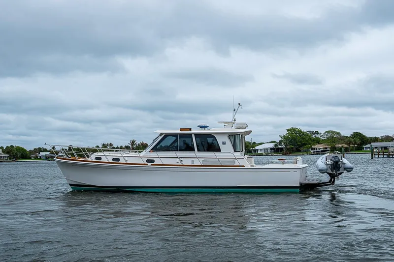 Slide: The Image of 2014 Grand Banks 46 Eastbay SX yacht on calm water under cloudy skies. - 59
