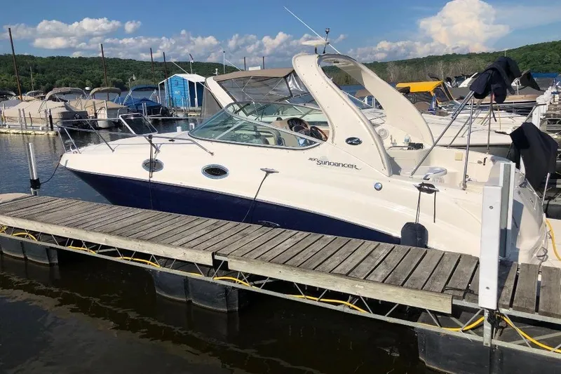 Slide: The Image of 2005 Sea Ray Sundancer 280 docked at a marina, surrounded by other boats. - 12