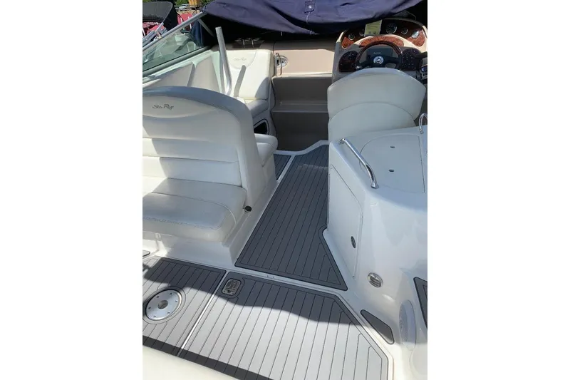 Slide: The Image of 2005 Sea Ray Sundancer 280 interior with white seating and sleek dashboard. - 4