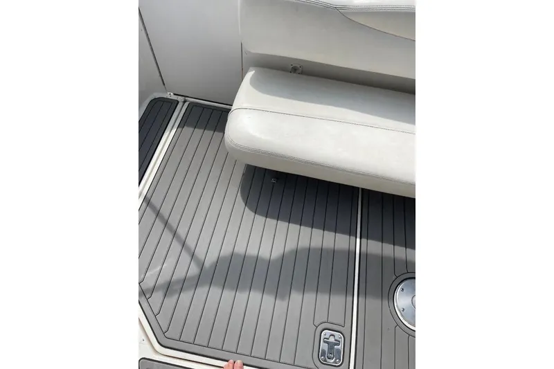 Slide: The Image of 2005 Sea Ray Sundancer 280 boat interior with gray flooring and white seating. - 8