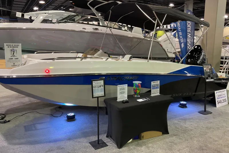 The Image of 2026 Starcraft SVX 211 OB boat displayed at an indoor exhibition with price details. - 0