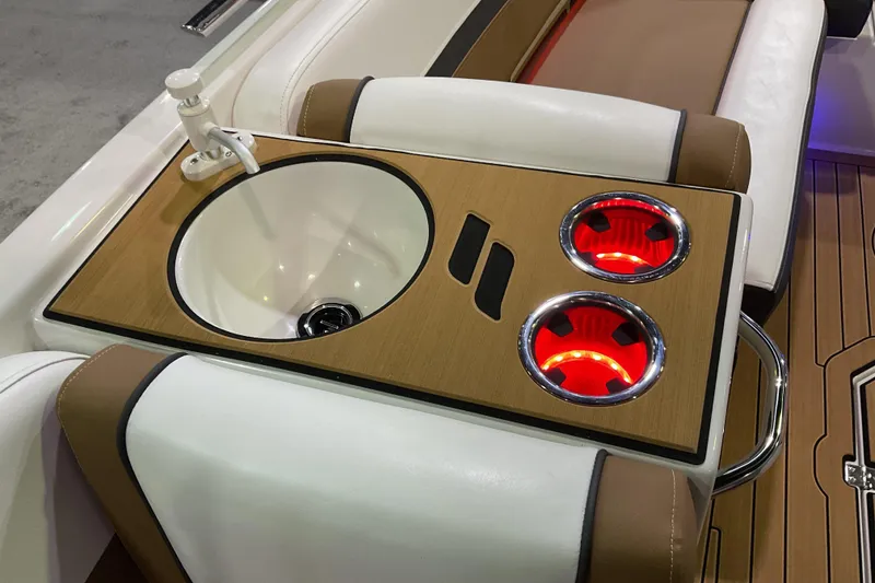 Slide: The Image of 2026 Starcraft SVX 211 OB boat interior with sink and illuminated cup holders. - 12