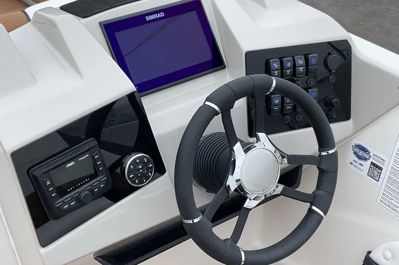 Slide: The Image of 2026 Starcraft SVX 211 OB boat dashboard with steering wheel and control panel. - 16