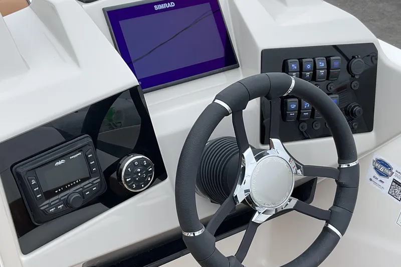 Slide: The Image of 2026 Starcraft SVX 211 OB boat dashboard with steering wheel and control panel. - 17