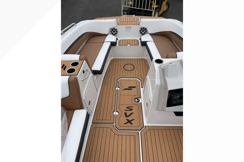 Slide: The Image of 2026 Starcraft SVX 211 OB boat interior with tan seating and wood-patterned flooring. - 19