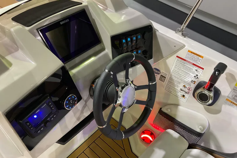Slide: The Image of 2026 Starcraft SVX 211 OB boat dashboard with steering wheel and control panel. - 7