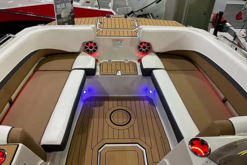 Slide: The Image of 2026 Starcraft SVX 211 OB boat interior with cushioned seating and ambient lighting. - 8