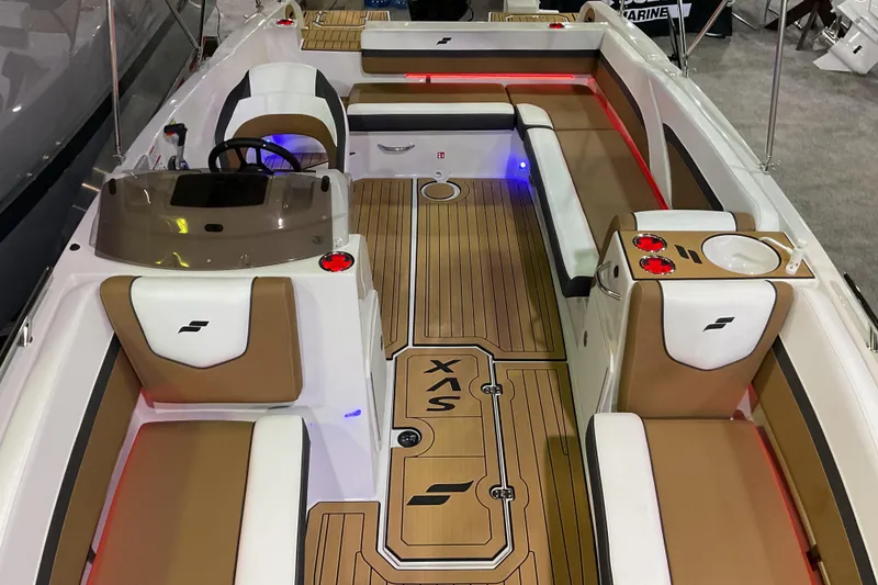 Slide: The Image of 2026 Starcraft SVX 211 OB boat interior with tan and white seating, modern design. - 9