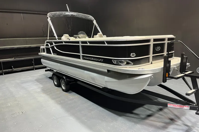 The Image of 2023 Princecraft Vectra 23 pontoon boat on trailer in indoor setting. - 1