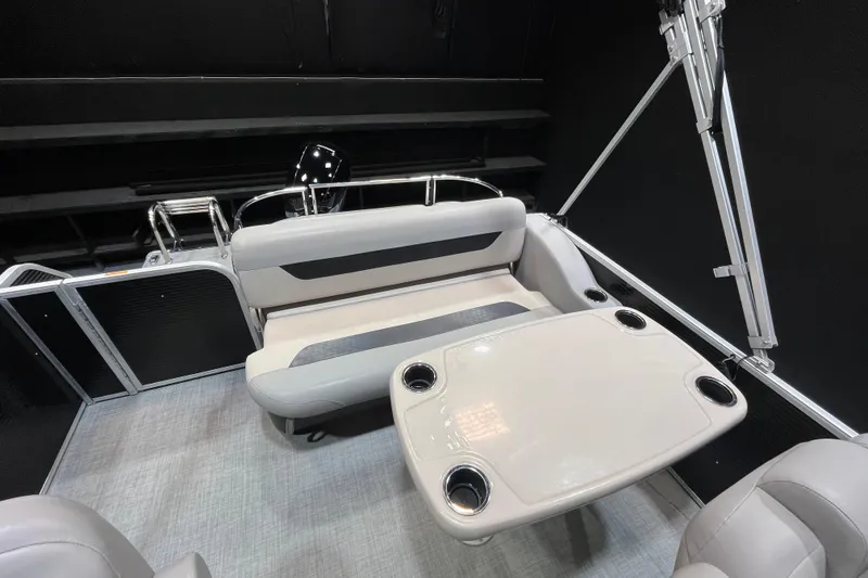 Slide: The Image of 2023 Princecraft Vectra 23 boat interior with seating and table, featuring cup holders. - 12