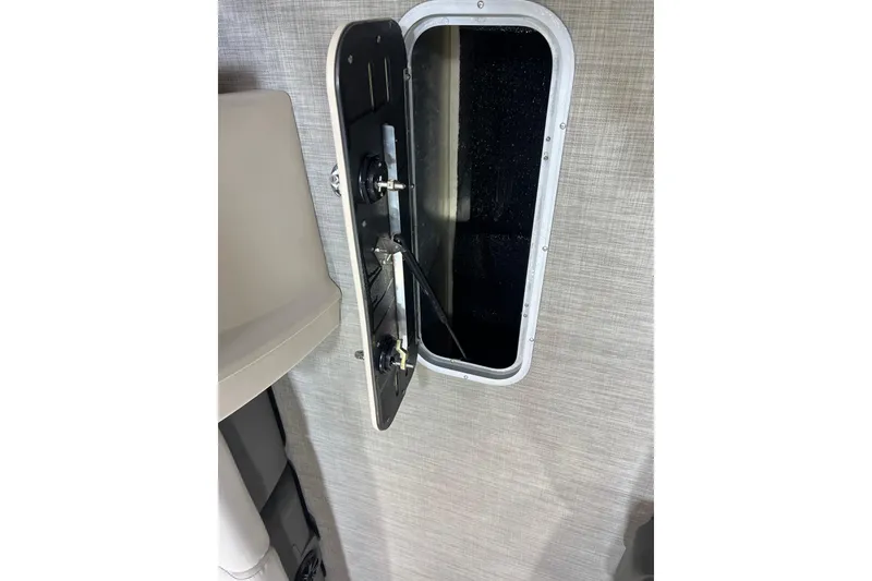 Slide: The Image of Open hatch on 2023 Princecraft Vectra 23 boat, showing interior components. - 17