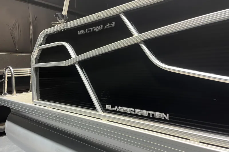 Slide: The Image of 2023 Princecraft Vectra 23 Classic Edition pontoon boat, sleek black exterior. - 5