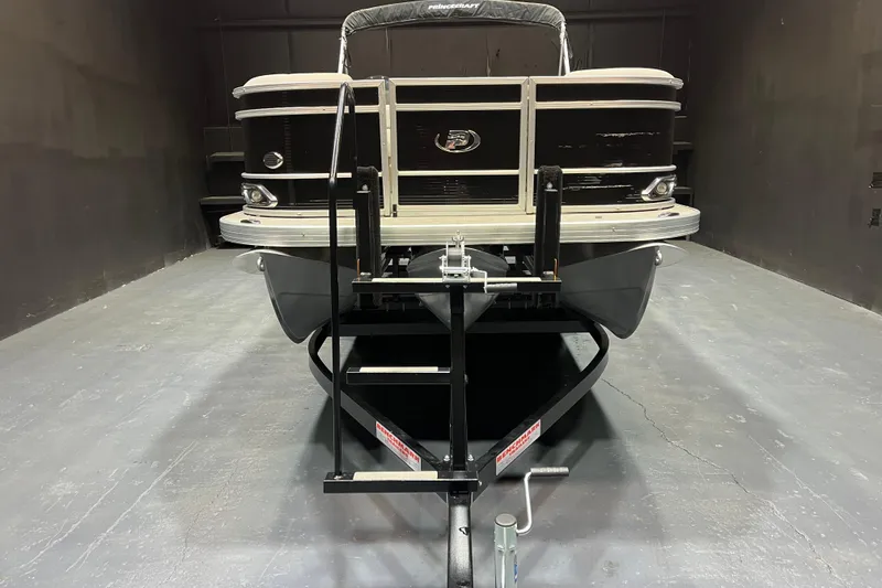 Slide: The Image of 2023 Princecraft Vectra 23 pontoon boat on trailer in a dimly lit garage. - 6