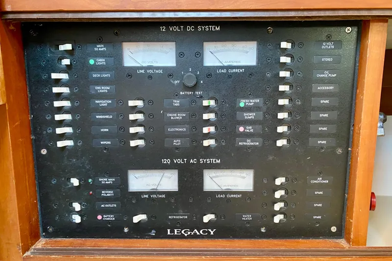 Slide: The Image of Interior of 2003 Legacy Yachts 28, featuring cozy cabin with beds and kitchenette. - 10