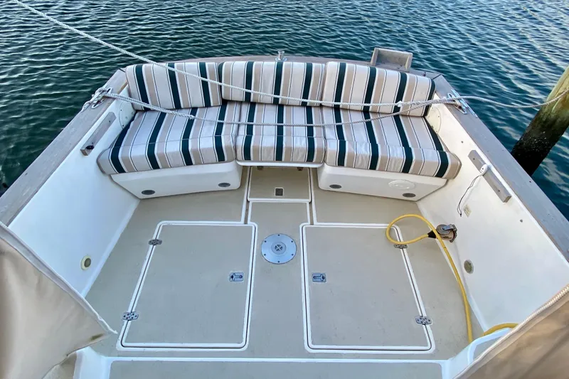 Slide: The Image of Helm of 2003 Legacy Yachts 28 with striped seating and control panel. - 17