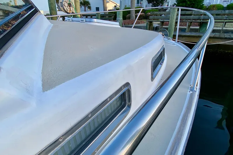 Slide: The Image of 2003 Legacy Yachts 28 interior with striped seating and wooden table. - 20