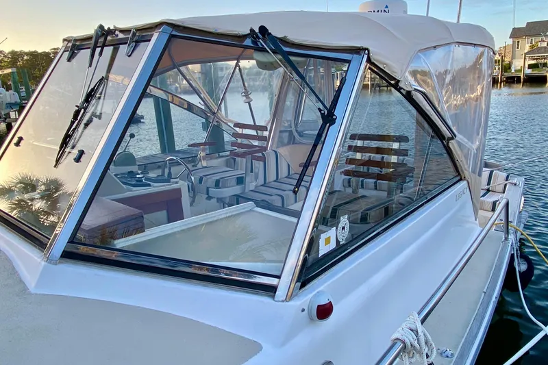 Slide: The Image of 2003 Legacy Yachts 28 boat deck with stainless steel railings and windows. - 23