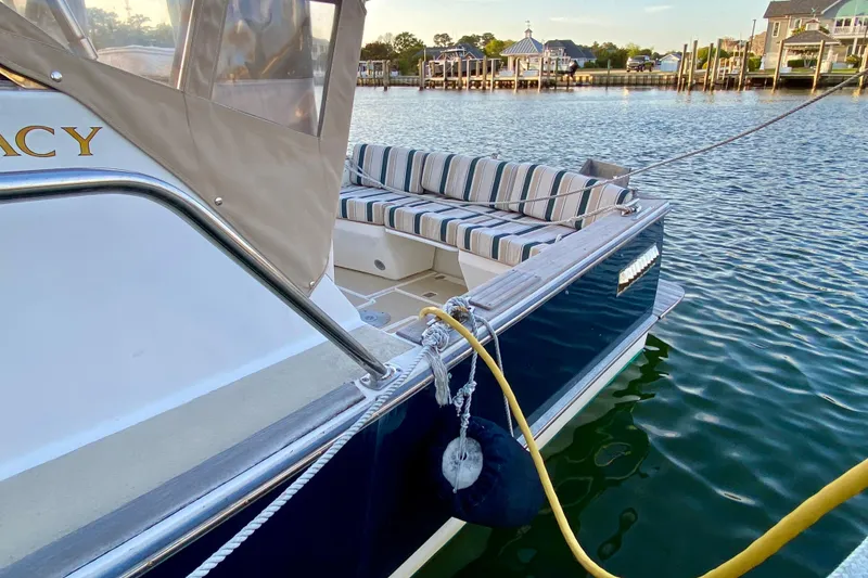 Slide: The Image of Bow of 2003 Legacy Yachts 28 at dock, featuring anchor and deck details. - 24