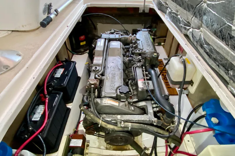 Slide: The Image of 2003 Legacy Yachts 28 docked, featuring striped seating and calm waters in the background. - 27