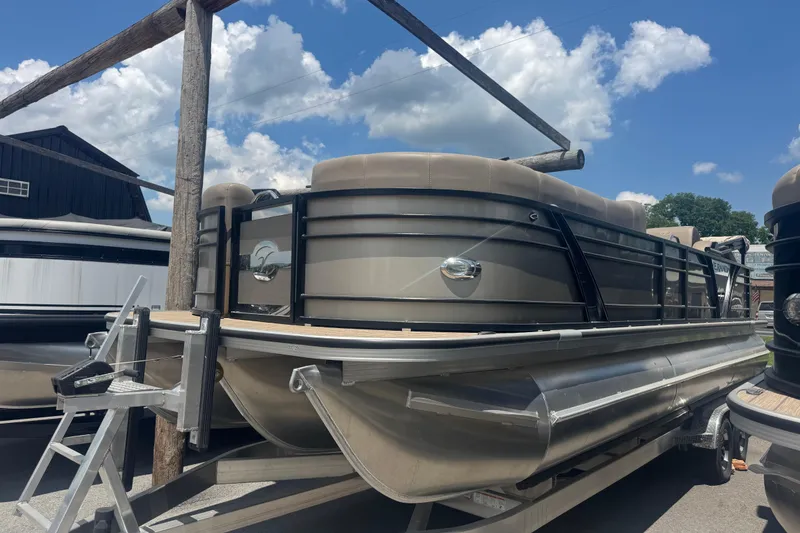 The Image of 2023 Veranda VTX 25RFL pontoon boat on trailer under blue sky. - 0
