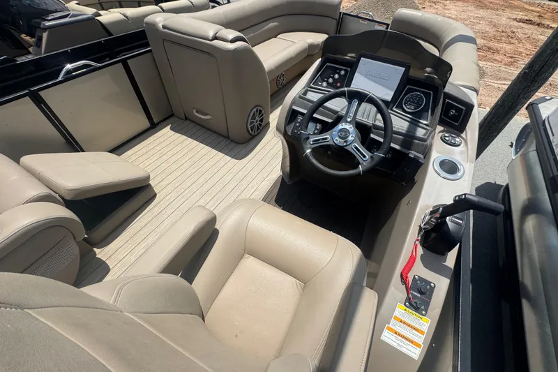 Slide: The Image of 2023 Veranda VTX 25RFL boat interior with beige seating and modern steering console. - 6