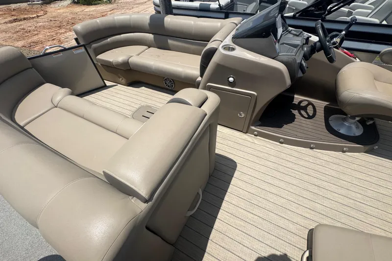 Slide: The Image of 2023 Veranda VTX 25RFL pontoon boat interior with beige seating and helm. - 7