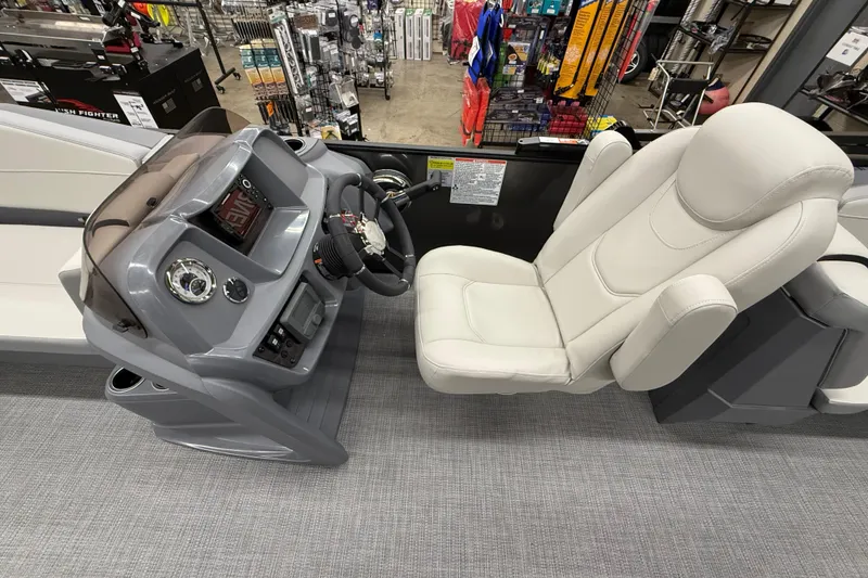 Slide: The Image of 2025 SunChaser Lucerne 22 LR DH boat interior with steering console and plush captain's chair. - 13
