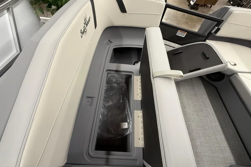 Slide: The Image of 2025 SunChaser Lucerne 22 LR DH boat interior with storage compartment and seating. - 14