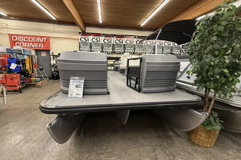 Slide: The Image of 2025 SunChaser Lucerne 22 LR DH pontoon boat displayed indoors with award banners. - 3