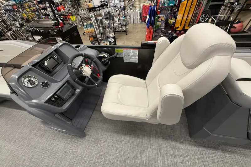 Slide: The Image of Captain's seat and helm of 2025 SunChaser Lucerne 22 LR DH boat in showroom. - 6