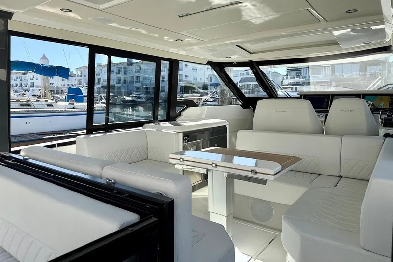 Slide: The Image of Luxurious interior of 2026 Saxdor 400 GTC yacht with white seating and marina view. - 19