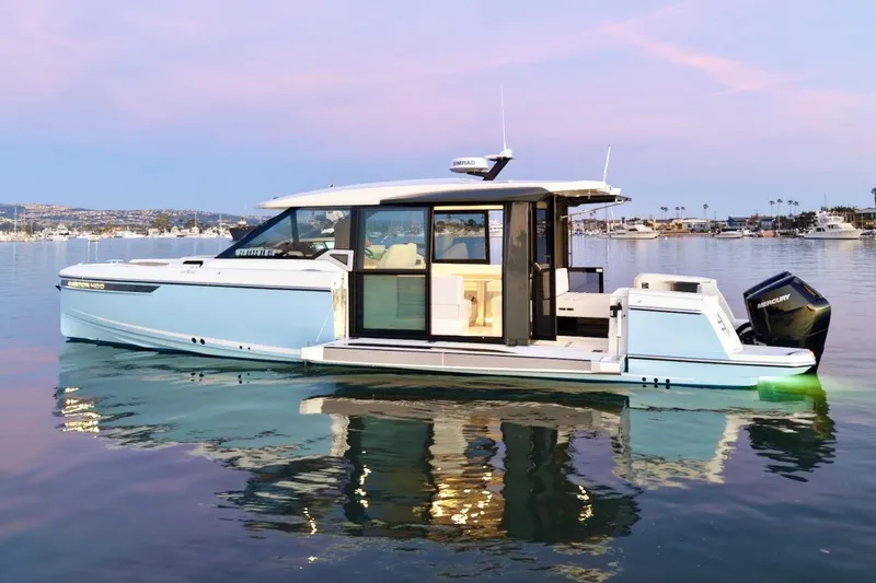 Slide: The Image of 2026 Saxdor 400 GTC luxury boat on calm water at sunset. - 2