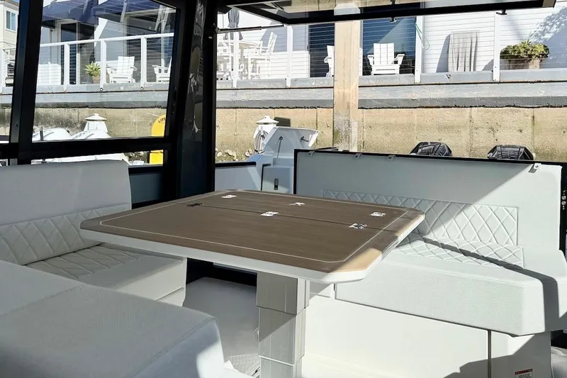Slide: The Image of Interior of 2026 Saxdor 400 GTC yacht with elegant seating and wooden table. - 24