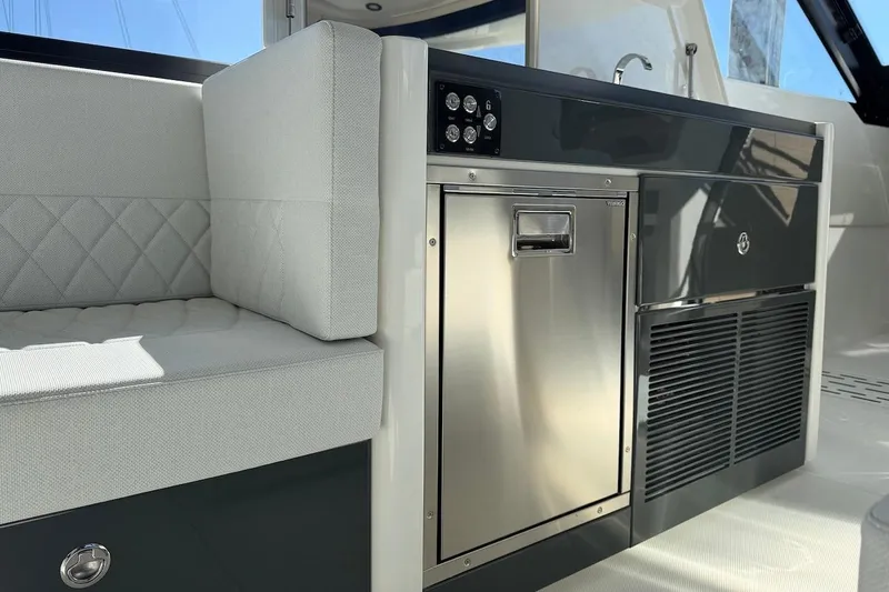 Slide: The Image of Interior of 2026 Saxdor 400 GTC yacht featuring modern seating and stainless steel appliances. - 26