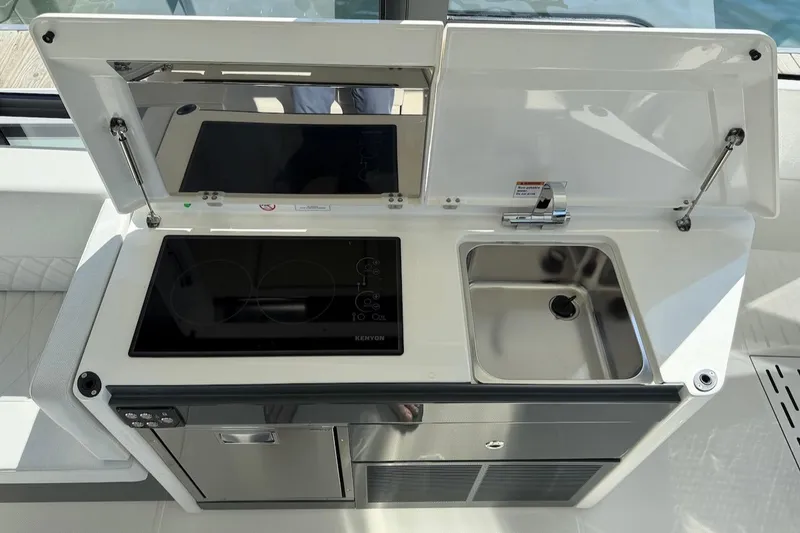 Slide: The Image of Compact kitchen setup on Saxdor 400 GTC 2026 boat, featuring stove and sink. - 27