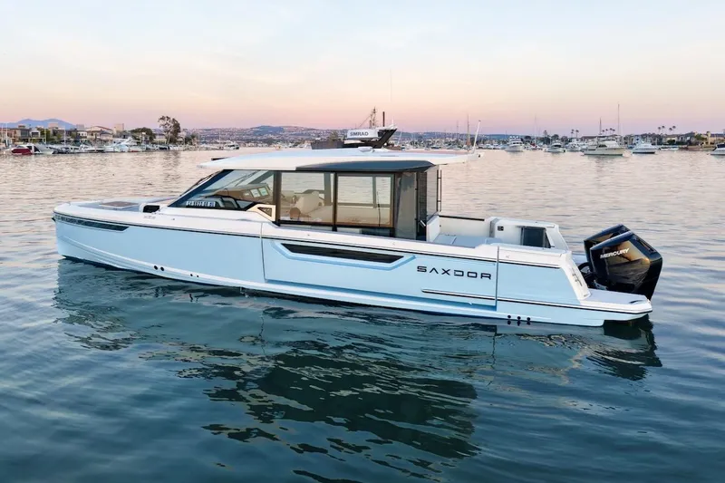 Slide: The Image of 2026 Saxdor 400 GTC boat on calm water at sunset, showcasing sleek design. - 3