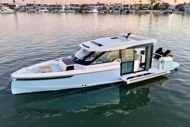 Slide: The Image of 2026 Saxdor 400 GTC luxury boat on calm water near waterfront homes. - 4