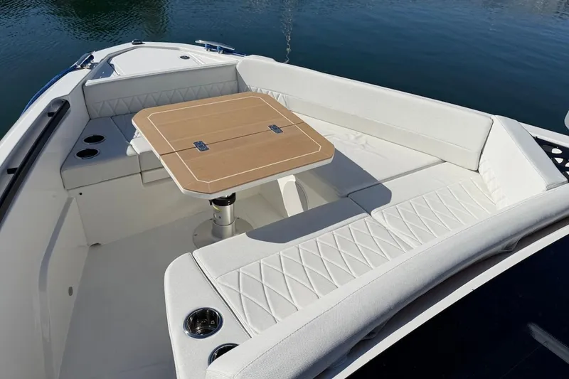 Slide: The Image of Luxurious seating area on the 2026 Saxdor 400 GTC boat with a wooden table. - 41